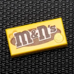 The Brick Show Shop M&N's (Peanut) - B3 Customs® Printed 1x2 Tile made using LEGO part